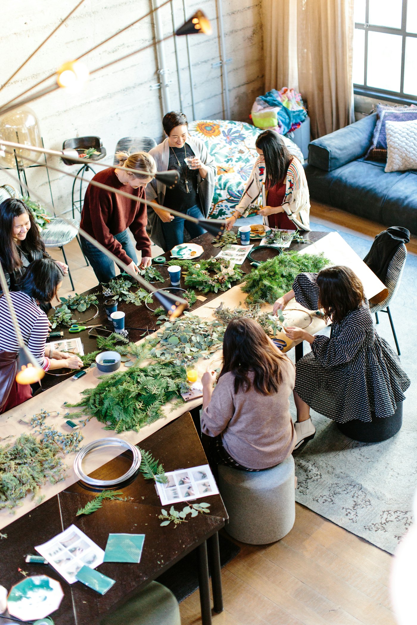 A group of people making things together around a big table