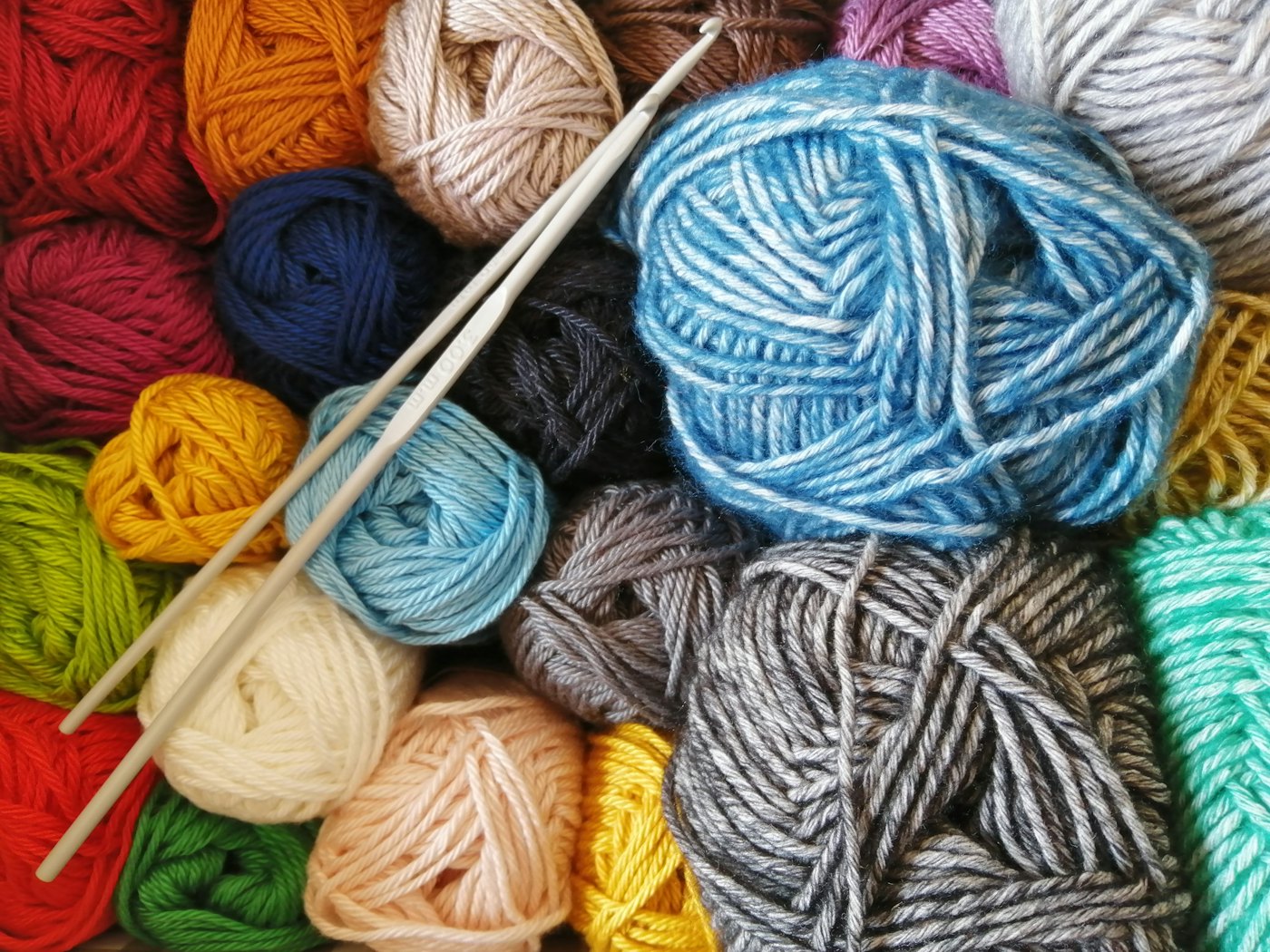Colourful balls of wool with knitting needles
