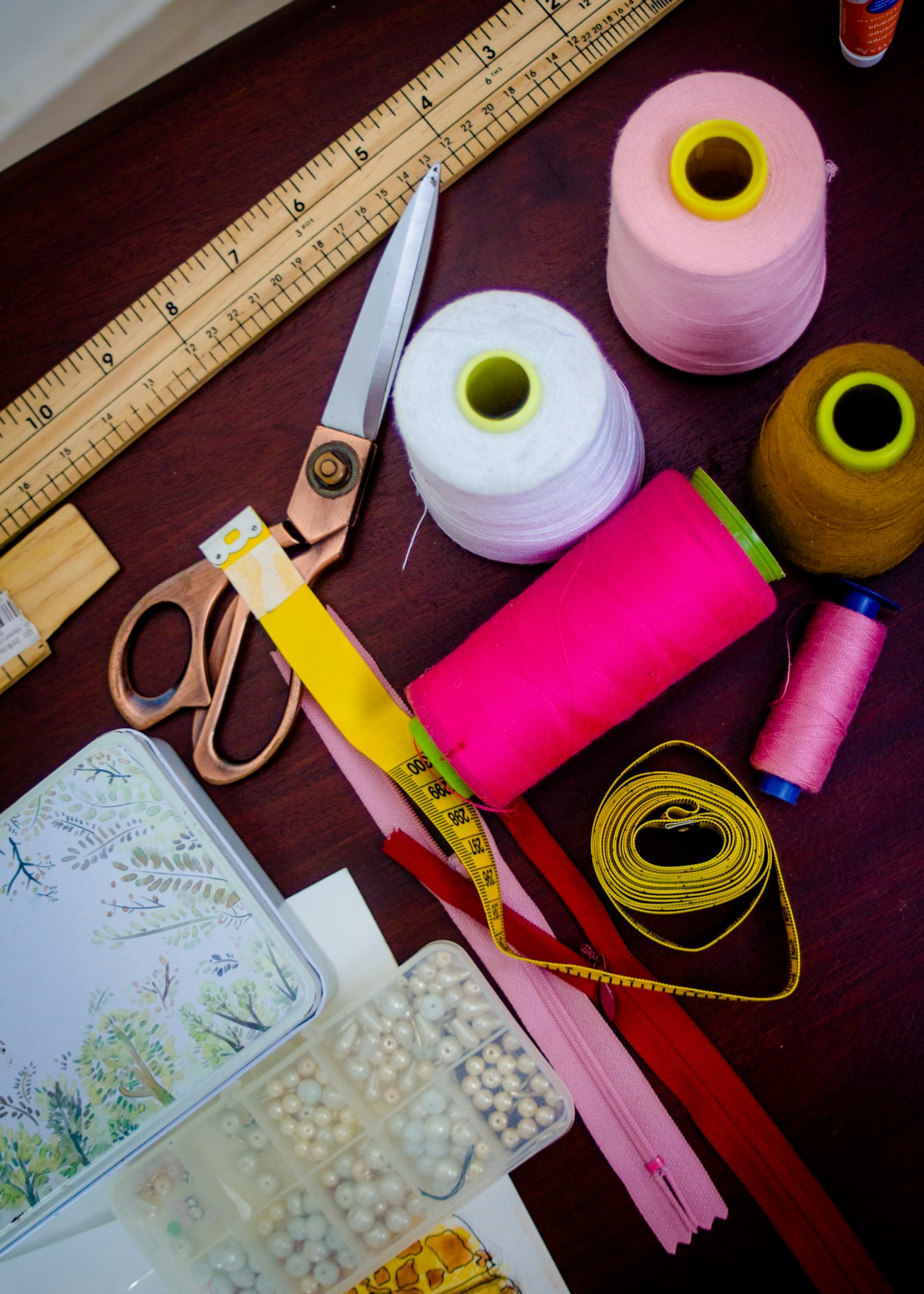 Bright reels of thread, scissors and a tape measure
